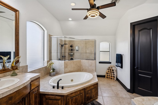 bathroom with tile patterned floors, a wealth of natural light, and lofted ceiling