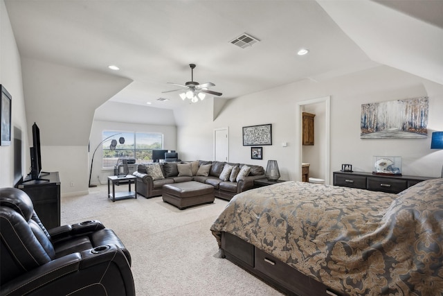 bedroom with connected bathroom, light colored carpet, ceiling fan, and lofted ceiling