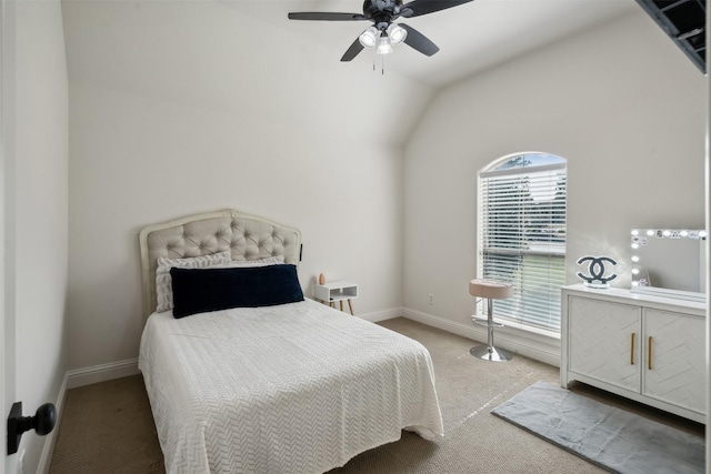 carpeted bedroom with ceiling fan and vaulted ceiling