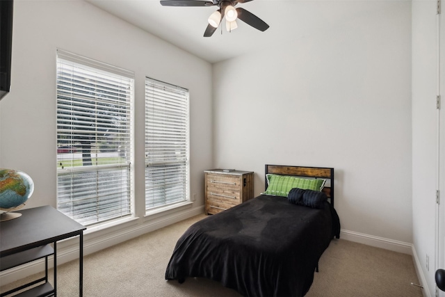 bedroom with ceiling fan and light carpet