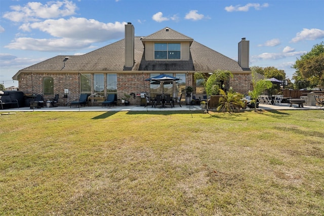 back of house with a yard and a patio area