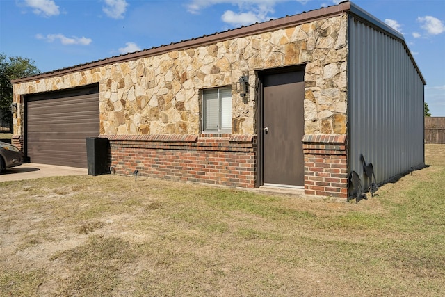 view of outdoor structure with a lawn and a garage