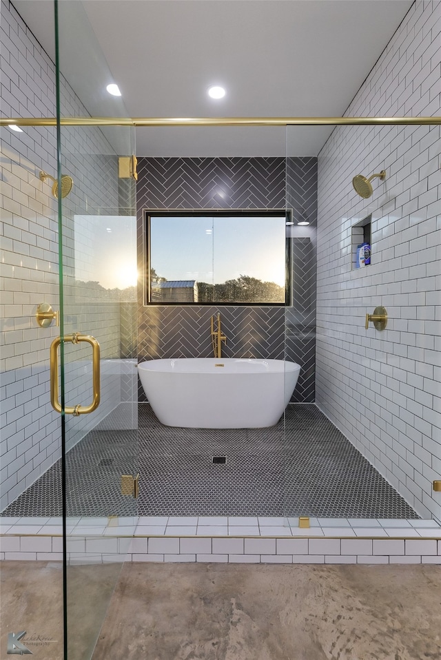 bathroom featuring independent shower and bath and concrete flooring