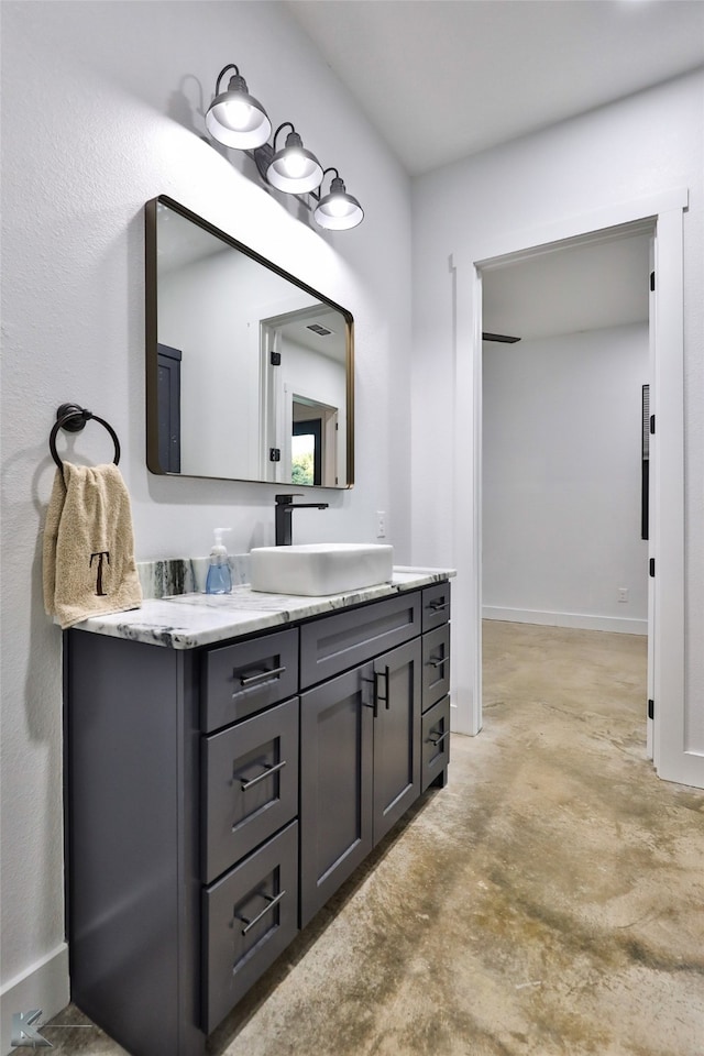 bathroom with vanity and concrete flooring