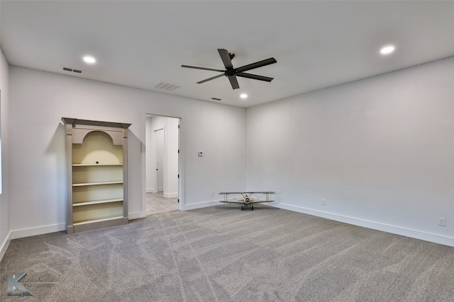 empty room featuring light colored carpet and ceiling fan