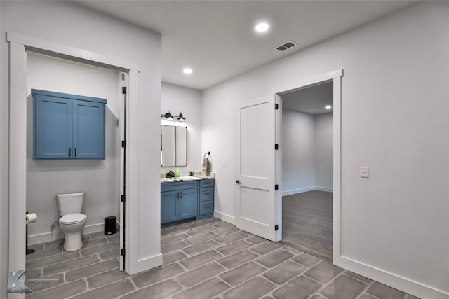 bathroom featuring toilet and vanity