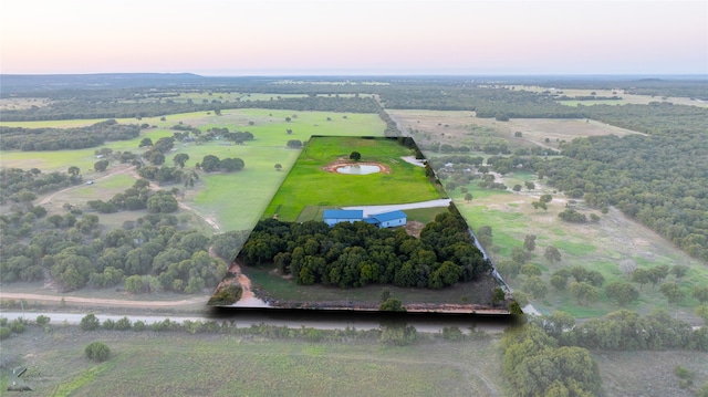 aerial view at dusk featuring a rural view