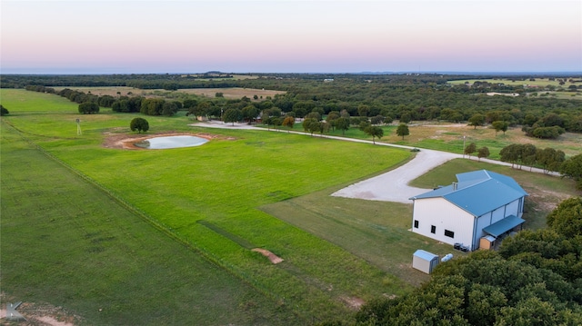 aerial view at dusk featuring a rural view