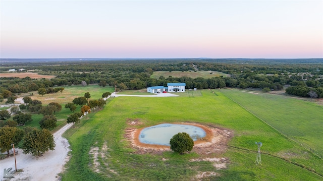 aerial view at dusk featuring a rural view