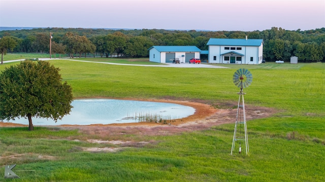 view of home's community featuring a yard and a water view