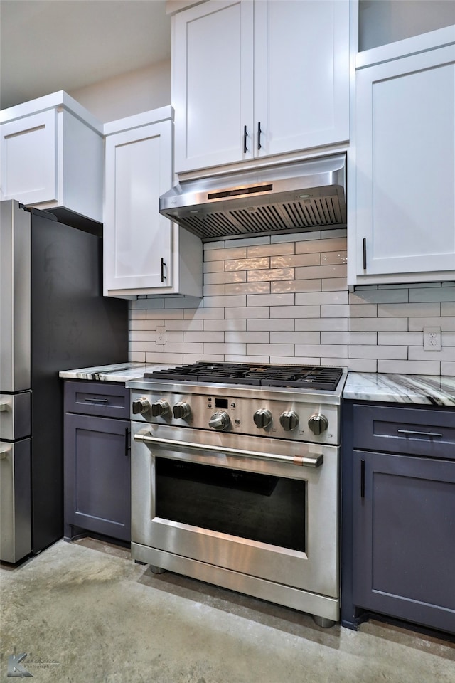 kitchen with decorative backsplash, white cabinets, stainless steel appliances, and light stone counters