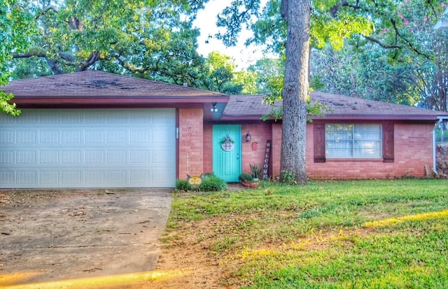 ranch-style home featuring a front lawn and a garage