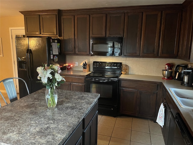 kitchen featuring tasteful backsplash, black appliances, sink, light tile patterned flooring, and dark brown cabinetry