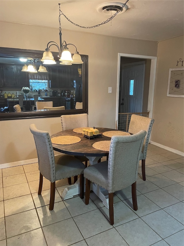 tiled dining space with an inviting chandelier