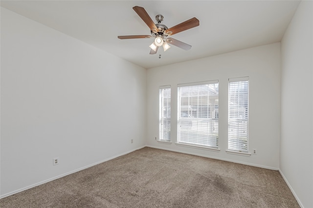 empty room featuring carpet flooring and ceiling fan