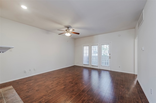 spare room featuring dark wood-type flooring and ceiling fan