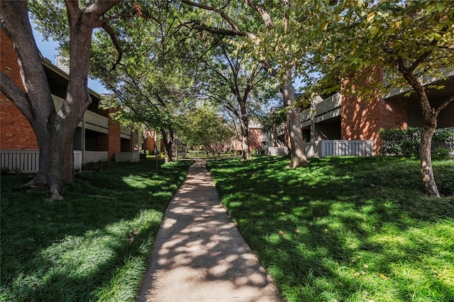 view of property's community with a lawn