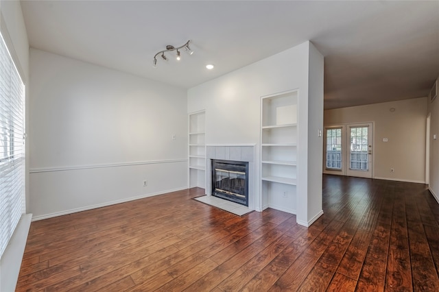 unfurnished living room with a fireplace and dark hardwood / wood-style flooring