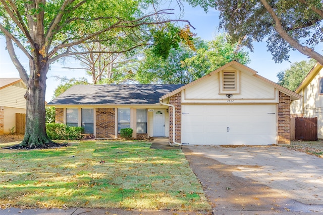 single story home with a garage and a front lawn