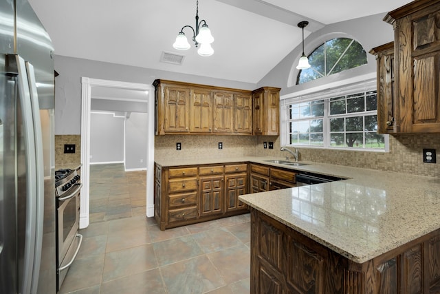 kitchen with decorative backsplash, hanging light fixtures, kitchen peninsula, vaulted ceiling, and appliances with stainless steel finishes