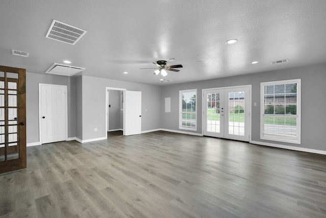 unfurnished living room with french doors, ceiling fan, wood-type flooring, and a textured ceiling