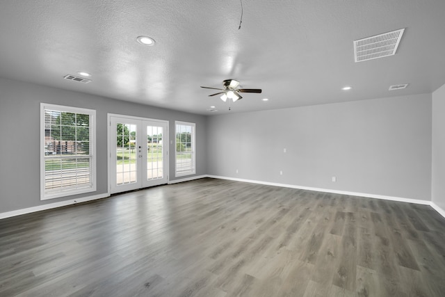 empty room featuring french doors, wood-type flooring, a textured ceiling, and ceiling fan