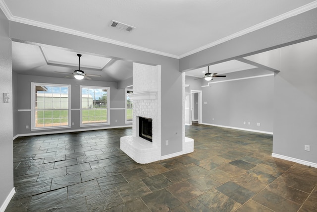 unfurnished living room featuring crown molding, ceiling fan, and a brick fireplace