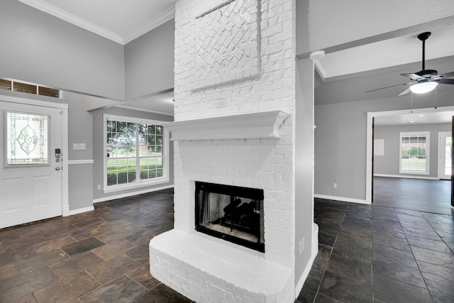 unfurnished living room with ceiling fan, crown molding, and a fireplace