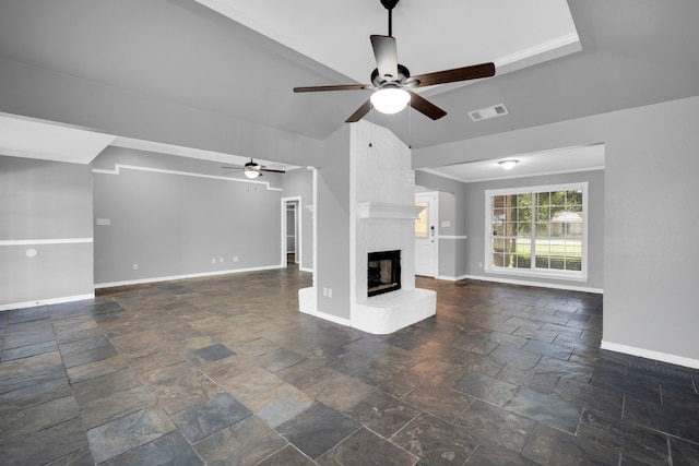 unfurnished living room with ornamental molding, vaulted ceiling, a fireplace, and ceiling fan