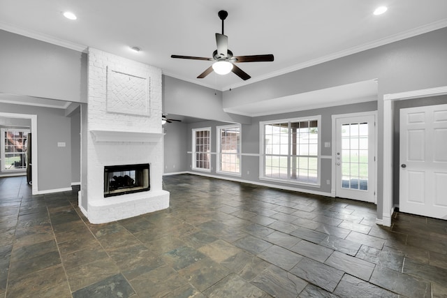 unfurnished living room with ceiling fan, ornamental molding, and a brick fireplace