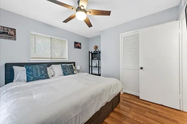 bedroom featuring hardwood / wood-style floors, a closet, and ceiling fan