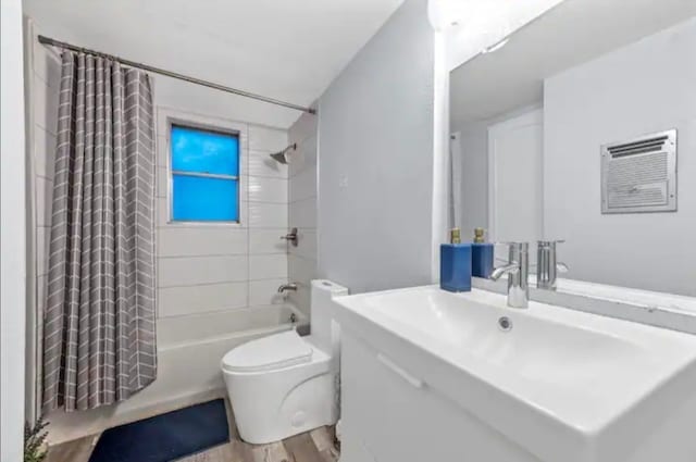 full bathroom featuring vanity, toilet, wood-type flooring, and shower / bath combo