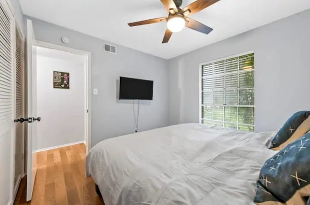 bedroom with wood-type flooring and ceiling fan