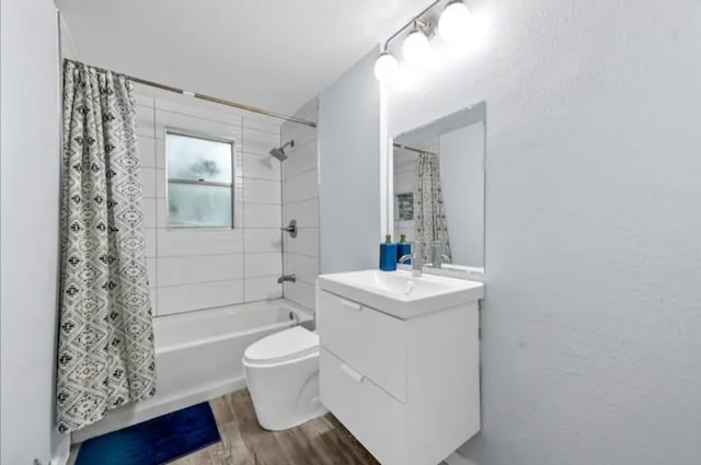 full bathroom featuring vanity, toilet, hardwood / wood-style flooring, and shower / bath combo