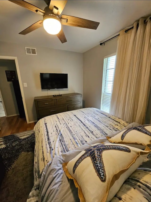 bedroom with hardwood / wood-style flooring and ceiling fan