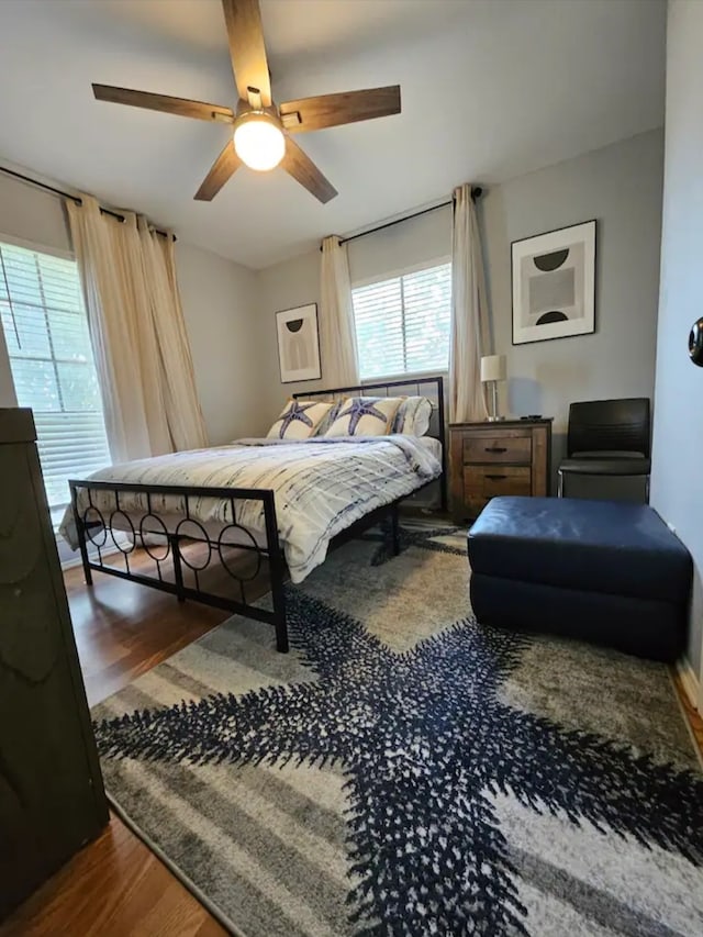 bedroom with ceiling fan and dark hardwood / wood-style flooring