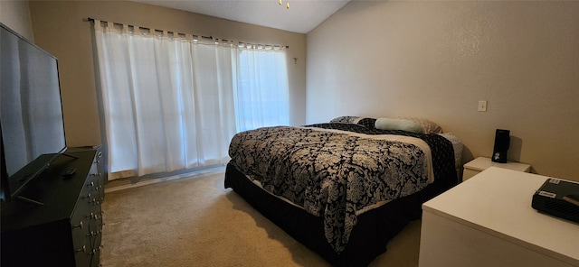 carpeted bedroom featuring lofted ceiling