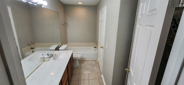 bathroom featuring toilet, vanity, tile patterned floors, and a bath