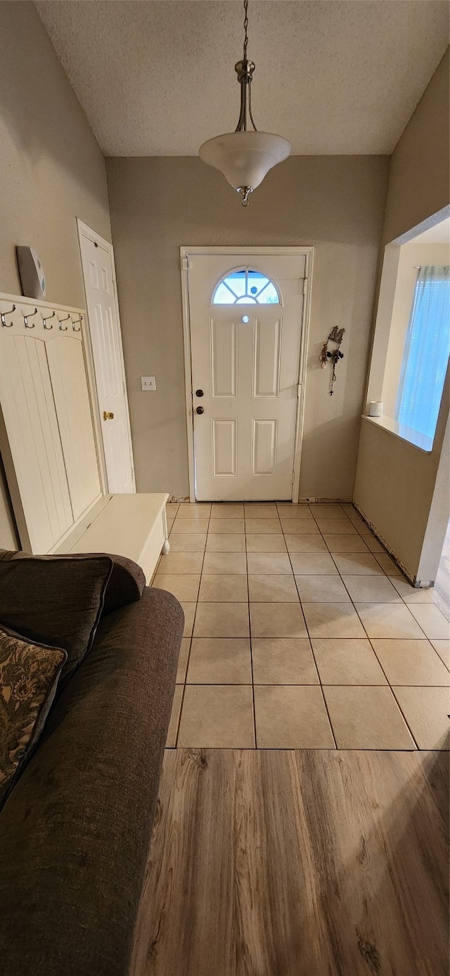 entrance foyer featuring light hardwood / wood-style floors and a textured ceiling