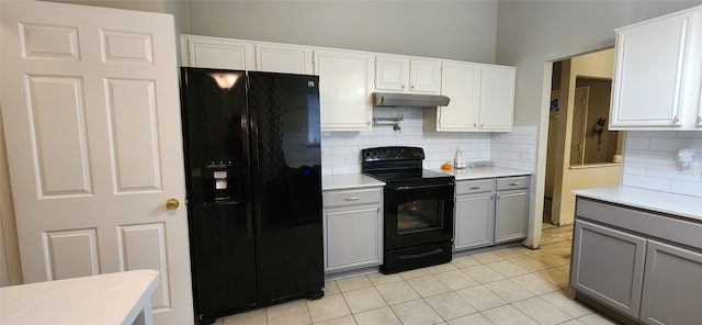 kitchen with gray cabinetry, black appliances, and white cabinetry