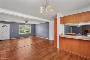 kitchen featuring ceiling fan with notable chandelier, dark hardwood / wood-style floors, and hanging light fixtures