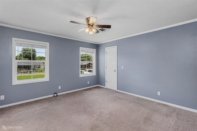 carpeted empty room featuring ornamental molding, a textured ceiling, a healthy amount of sunlight, and ceiling fan