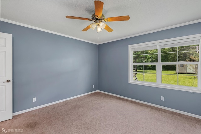 empty room with ornamental molding, a textured ceiling, carpet floors, and ceiling fan