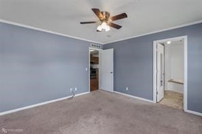 unfurnished bedroom featuring ceiling fan, ornamental molding, and carpet floors