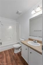 bathroom featuring toilet, vanity, and wood-type flooring