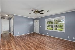 unfurnished room with crown molding, dark hardwood / wood-style flooring, and ceiling fan