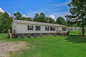 rear view of property featuring a yard