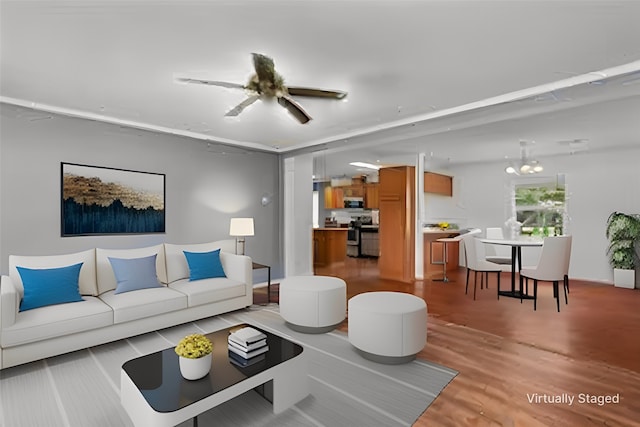 living room with light hardwood / wood-style floors and ceiling fan