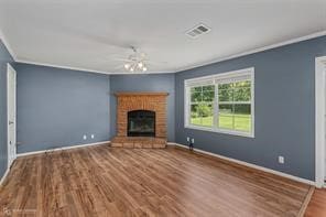 unfurnished living room featuring crown molding, a fireplace, and hardwood / wood-style flooring