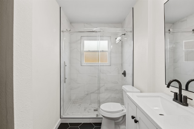 bathroom featuring tile patterned flooring, vanity, toilet, and an enclosed shower